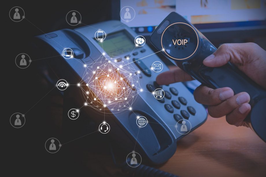 person dialing on a voip phone